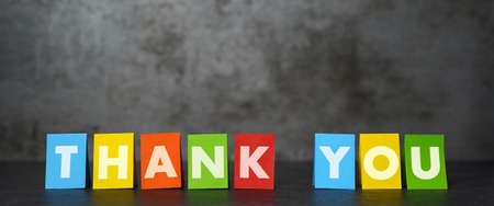 Thank you sign and word on colorful papers for thanks giving message to customers on dark grunge background with copy space.の写真素材