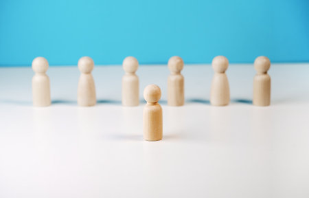 Leadership in business or team manager conceptual image with a wooden pawn leader standing out and leading among the follower on background.の写真素材