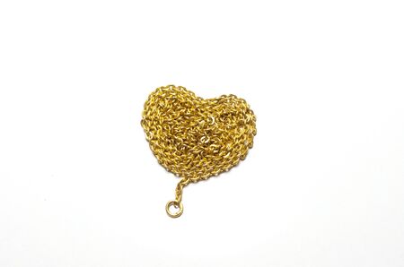 Gold chain with a heart-shaped arrangement  Isolated on a white background の写真素材