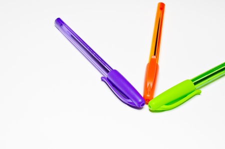 Pens, purple, green and orange. Isolated on a white background.の写真素材