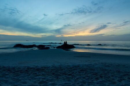 Couple in silhouette at sunrise in the morning.の写真素材