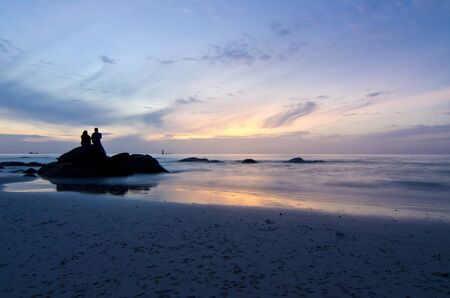 Couple in silhouette at sunrise in the morning.の写真素材