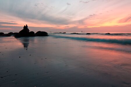 Couple in silhouette at sunrise in the morning.の写真素材