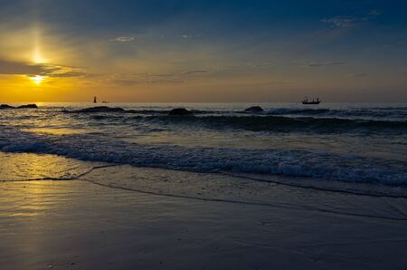Sunrise on the sea front is a stone beach の写真素材