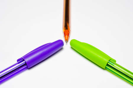 Pens, purple, green and orange. Isolated on a white background.の写真素材