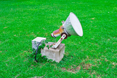 A large spotlight  Installed on a green lawn の写真素材