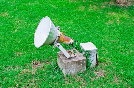 A large spotlight  Installed on a green lawn の写真素材