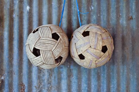 Rattan ball two plastic hanging on the wall of an old zinc の写真素材