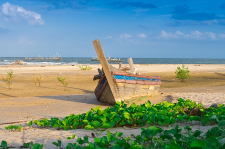 Wreck lying on the sandy beach at sunset.の写真素材