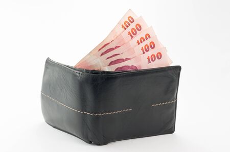 black leather wallet with money isolated on white backgroundの写真素材