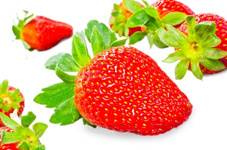Red strawberry fruits with green leaves isolated on white backgroundの写真素材