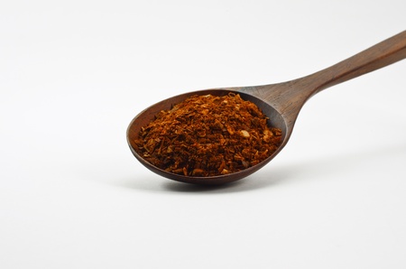 Cayenne red pepper in wooden spoon  Isolated on white の写真素材