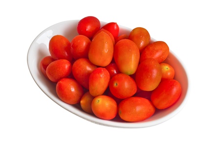 Red tomatoes in a white bowl  Isolated on a white background の写真素材