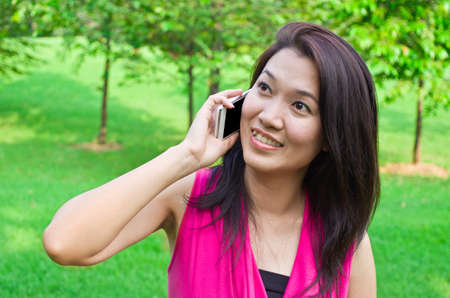 Portrait of a young Asian women on the phone の写真素材