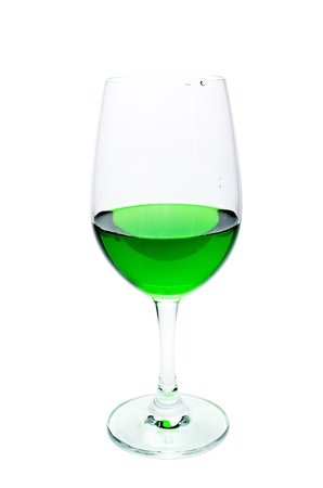 Green juice in a wine glass. Isolated on a white background.の写真素材
