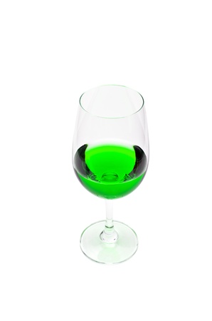 Green juice in a wine glass. Isolated on a white background.の写真素材