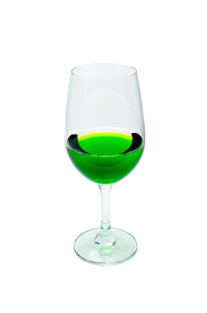 Green juice in a wine glass. Isolated on a white background.の写真素材