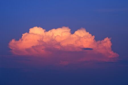 Golden clouds on a blue sky at sunset.の写真素材