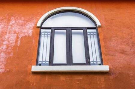 White vintage style window on the orange wall.の写真素材
