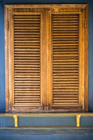 Brown vintage style window on the orange wall.の写真素材