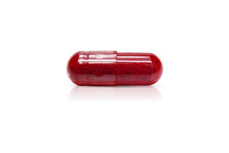 Herbal medicine capsules red. Isolated on white.の写真素材
