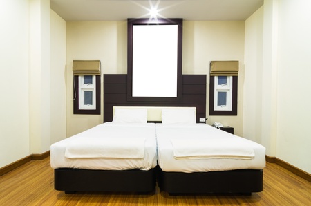 Double bed in a room with warm light.のeditorial素材