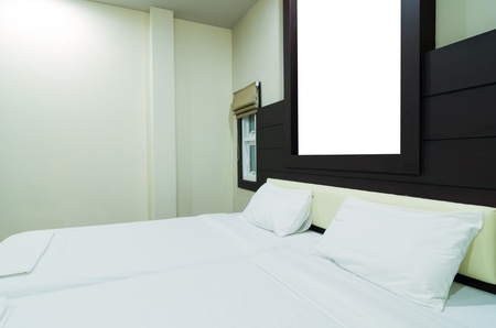 Double bed in a room with warm light.のeditorial素材