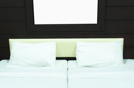 Double bed in a room with warm light.