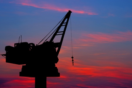 Crane for lifting heavy objects. The sky as a backdrop, at dusk.の写真素材