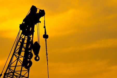 Crane for lifting heavy objects. The sky as a backdrop, at dusk.の写真素材
