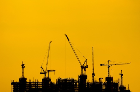 Silhouette crane construction industry and building work.の写真素材