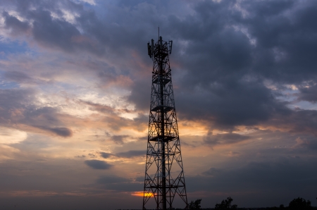 Silhouette in a large transmission tower at sunset beautiful.の写真素材