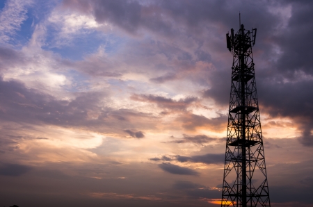 Silhouette in a large transmission tower at sunset beautiful.の写真素材