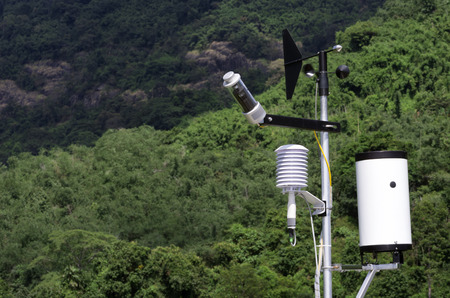 Wind speed measurement devices Against a backdrop of green trees on the mountain.の写真素材