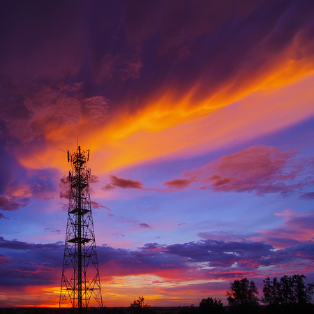 Silhouettes telecommunication tower at sunset. Beautiful sky.の写真素材