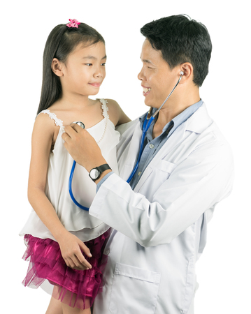 Male doctor examining little asian girl isolated on white.の写真素材