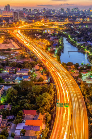 Landscape building modern business district of Bangkok Expressway in the foreground at sunset,...