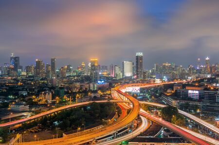 Landscape building modern business district of Bangkok. S-shaped expressway in the foreground at twilight.の写真素材