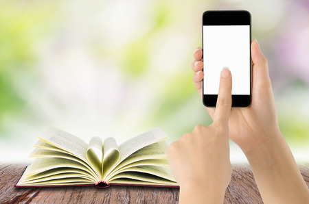 Woman Mobile Smartphone mobile phone over a blank notebook: Learning concepts or searches.の写真素材