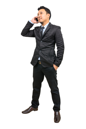 Businessman talking on phone. On a white background with clipping path.の写真素材