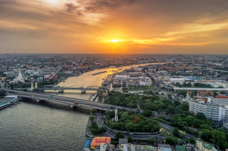 Landscape the area Phra Phuttha Yodfa Bridge is a bridge that links the capital to the communication between the Thonburi side of Bangkok at sunset.の写真素材