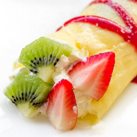 Roll crepes with berries and kiwi. Crepes, strawberry, raspberry, blueberry pancake topping.の写真素材