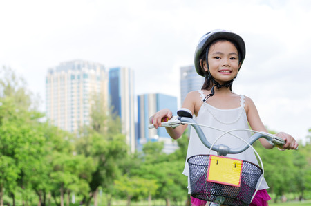 Asian young girl riding the bicycle with natural background.の写真素材