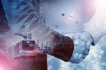Double exposure of businessman handshake on industrial business background.の写真素材
