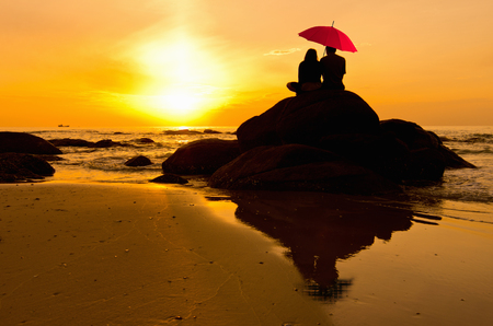 Silhouettes of couple against the sunset sky, Romantic.の写真素材