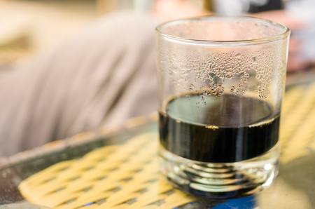 Black coffee in a transparent glass on the table.の写真素材