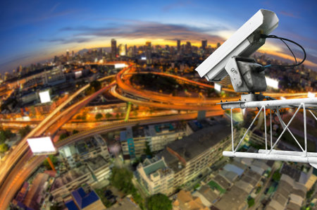 CCTV cameras, security cameras. With the backdrop tail lights blurred on the road from a high angle.