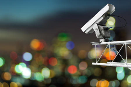 CCTV monitoring, security cameras. Backdrop with Cityscape view with blurred lights.の写真素材
