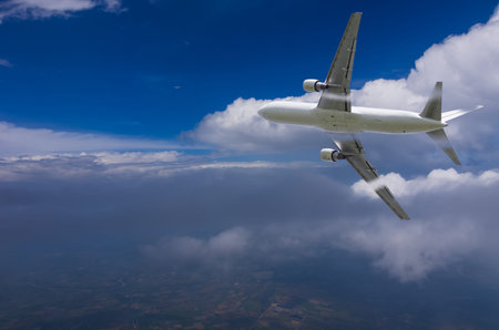 Airplane flying high above the clouds.
