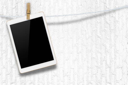 Hanging blank digital tablet computer with isolated screen with clipping path.の写真素材